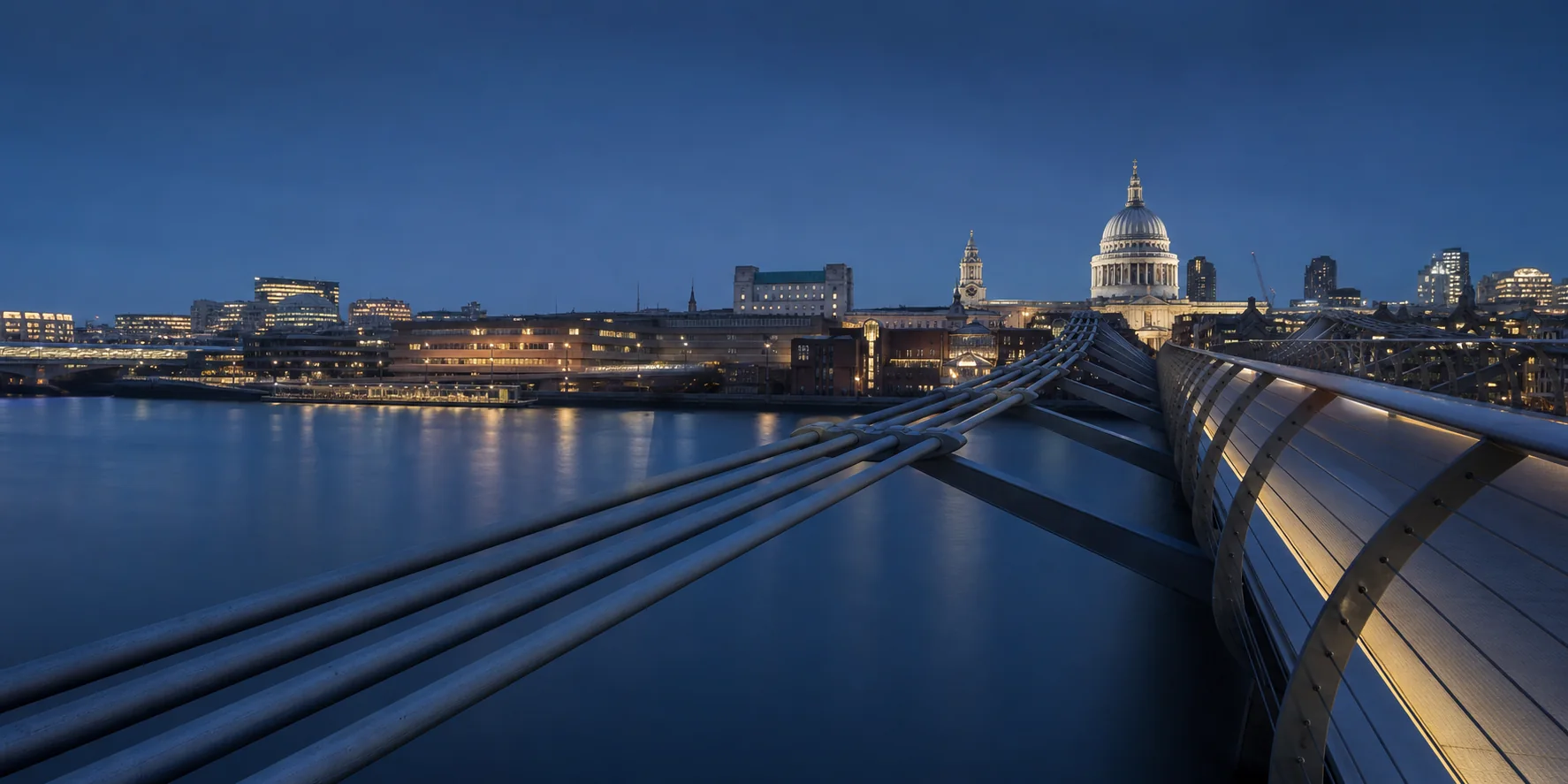 London bridge leading toward the city at blue hour